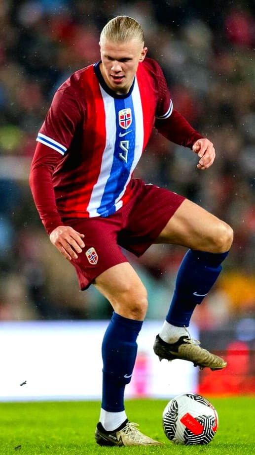 A soccer player in a red and blue Norway jersey controls a ball on a field during a match, as fans stream the action live via Nordic IPTV.