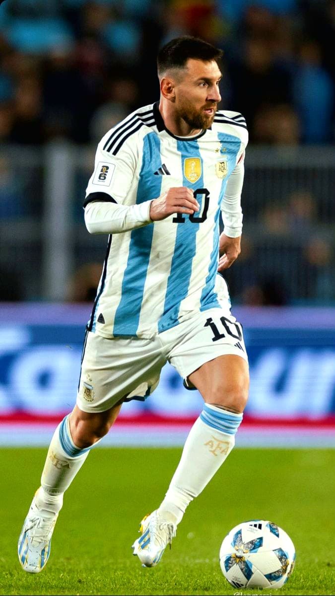 A soccer player in an Argentina jersey, number 10, is running on the field while dribbling a soccer ball during a match, as viewers enjoy the live action through Nordic IPTV.